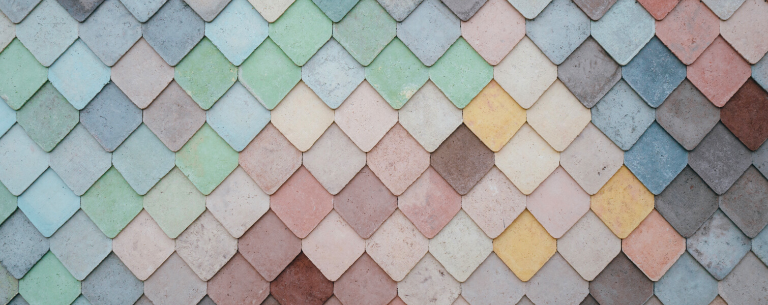 A multi coloured wall of diamond shape tiles